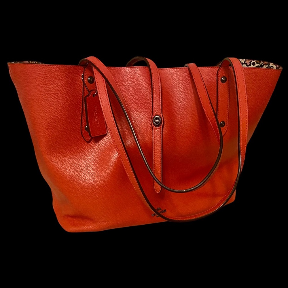 COACH Orange Pebble Leather Tote with Signature print interior.